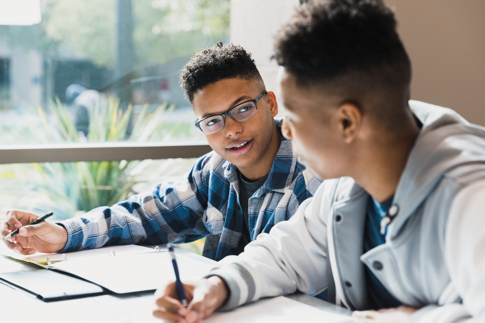 Two students reviewing a CV and application documents together