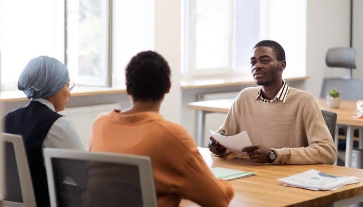 Young job applicant in an interview with two interviewers