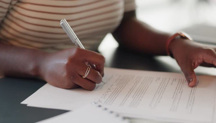 Person filling in a form to appeal a declined SASSA SRD grant