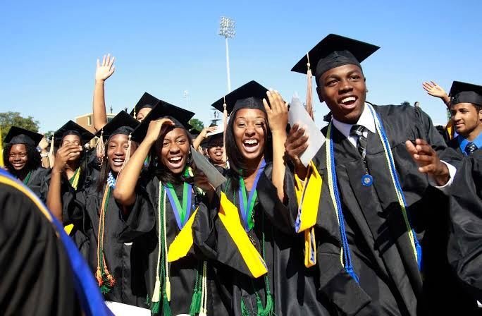 South African graduates celebrating in caps and gowns after completing their studies
